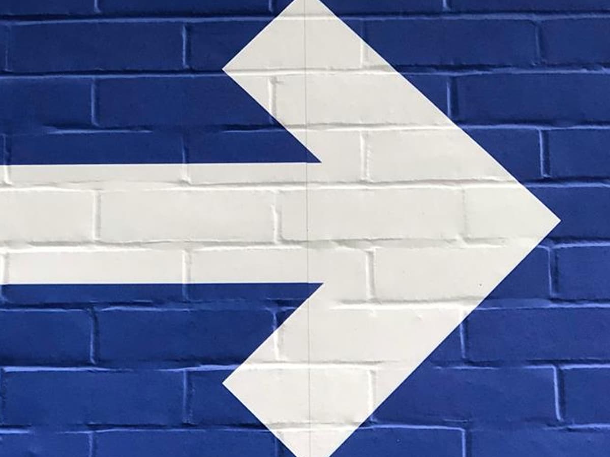 White arrow on blue background